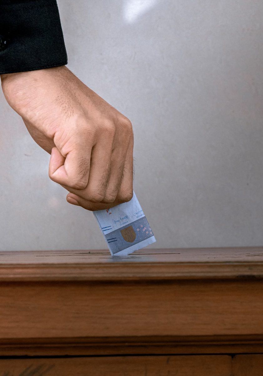 person holding white and blue soft tube